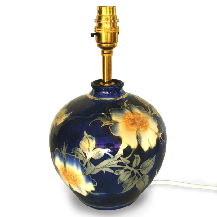 Small lampbase with wild rose design. Dynamic blue ground. Height 17 cm. Unique number 7746.